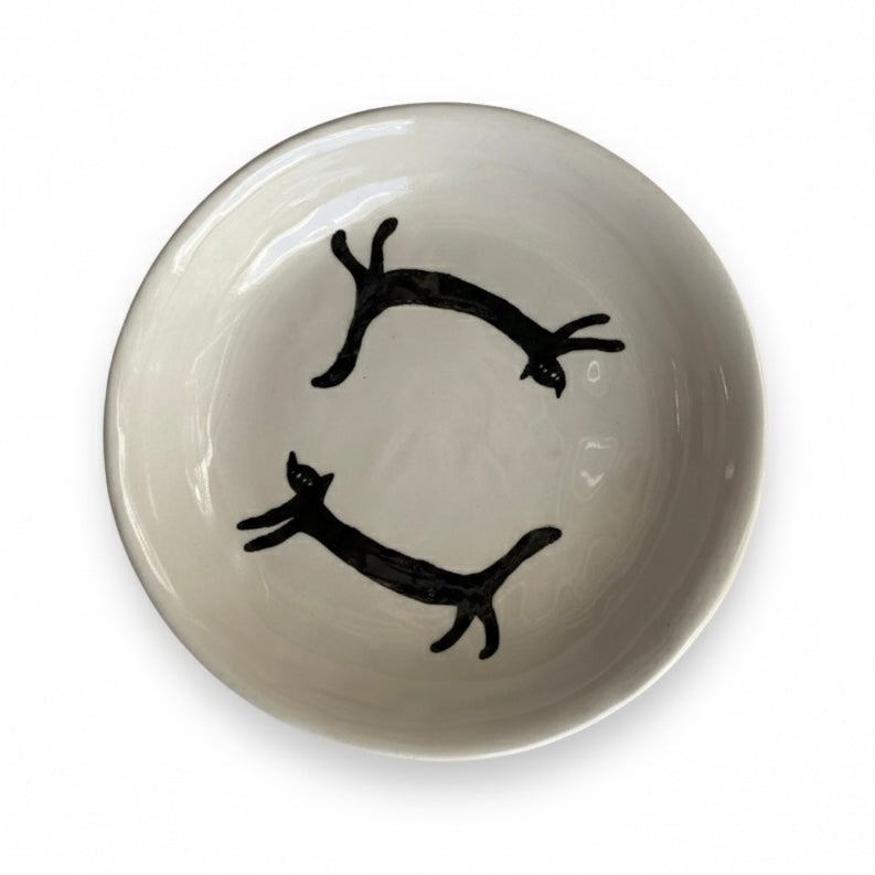 Two stretching black cats plate
